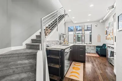 a kitchen with a sink and a staircase at Bright 1BR Office, Attached Garage & Fast WiFi in Denver