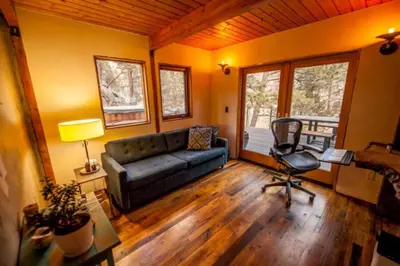 a living room with a couch and a chair at The Rusty Skillet Spa and Ranch in Boulder