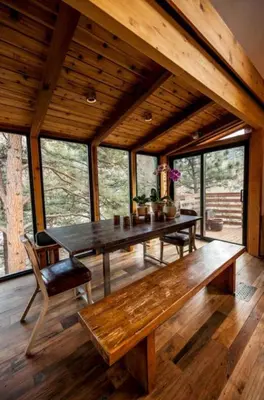 a dining room with a wooden table and a bench at The Rusty Skillet Spa and Ranch in Boulder