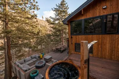 a cabin with a hot tub on a deck at The Rusty Skillet Spa and Ranch in Boulder