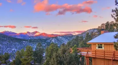 a house with a view of the mountains at Rocky Mountain Panorama Cabin in Estes Park