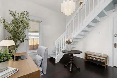 a white room with a desk and a staircase at The Wild Peony Walk to Old Town FC and CSU Campus in Fort Collins
