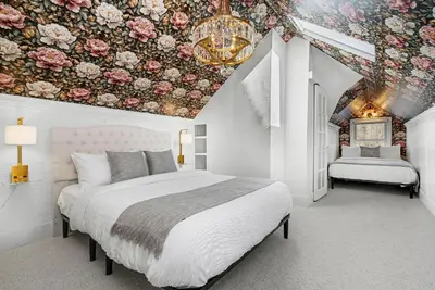 a bedroom with a bed and a floral ceiling at The Wild Peony Walk to Old Town FC and CSU Campus in Fort Collins