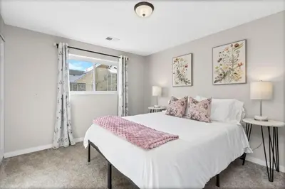 a bedroom with a white bed and a window at Chimney Park Retreat King Suite and Fenced Yard in Windsor