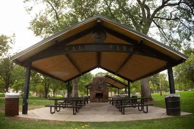 a pavilion with tables and benches in a park at Chimney Park Retreat King Suite and Fenced Yard in Windsor