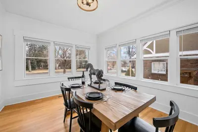a dining room with a table and chairs and windows at Campus Corner Retreat Two King Beds and Dog Friendly in Fort Collins