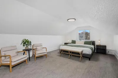 a bedroom with a bed and two chairs and a window at Campus Corner Retreat Two King Beds and Dog Friendly in Fort Collins