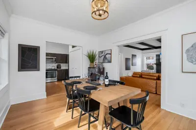 a dining room and living room with a table and chairs at Campus Corner Retreat Two King Beds and Dog Friendly in Fort Collins