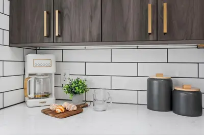 a kitchen counter with a coffee maker and a cutting board at Campus Corner Retreat Two King Beds and Dog Friendly in Fort Collins