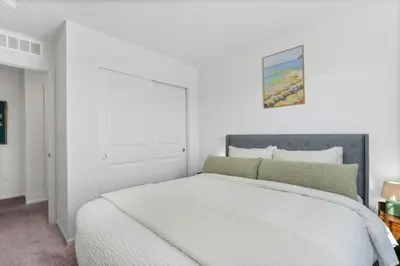 a white bedroom with a large white bed in it at Pelican Landing Modern 3BD in Lakes at Centerra in Loveland