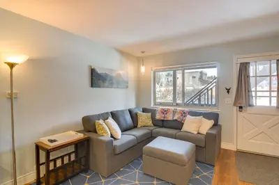 a living room with a couch and a door at 3 Mi to Slopes! Family-Friendly Winter Park Escape in Winter Park