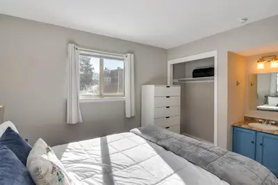 a bedroom with a bed and a sink and a mirror at 3 Mi to Slopes! Family-Friendly Winter Park Escape in Winter Park