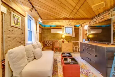 a living room with a couch in a tiny house at Explore CU! Unique Studio with Private Courtyard in Boulder