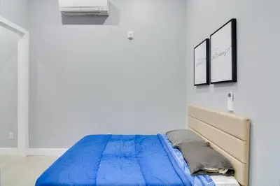 a bedroom with a blue bed and a white wall at Steps to Casinos and Shuttle! Central City Home Base in Central City