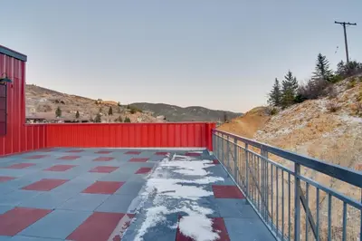 a red fence and snow on a patio at Steps to Casinos and Shuttle! Central City Home Base in Central City