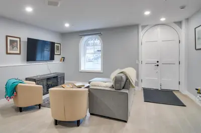 a living room with a couch and a tv at Walkable Townhome in the Heart of Central City! in Central City