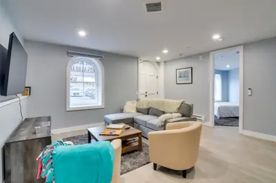 a living room with a couch and a table at Walkable Townhome in the Heart of Central City! in Central City