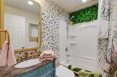 a bathroom with a sink and a mirror and a tub at 2 Mi to Old Town Pet-Friendly Home Base in Arvada in Arvada