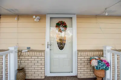 a front door of a house with a wreath and flowers at 2 Mi to Old Town Pet-Friendly Home Base in Arvada in Arvada