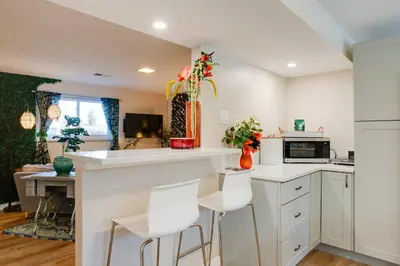 a kitchen with white counters and white stools at Work and Play Near Old Town Arvada Pets Welcome! in Arvada