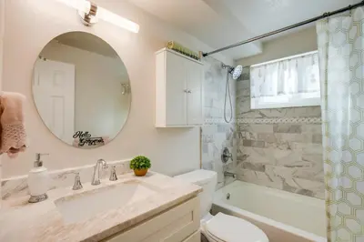 a bathroom with a sink and a toilet and a mirror at Work and Play Near Old Town Arvada Pets Welcome! in Arvada