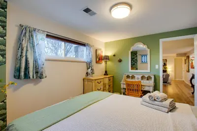 a bedroom with a bed and a window and a chair at Work and Play Near Old Town Arvada Pets Welcome! in Arvada