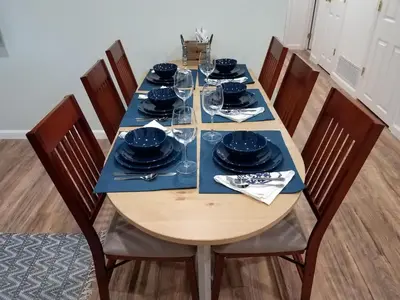 a dining room table with blue plates and glasses at Renovated 2BR flat near Red Rocks-Rocky Mt-DT-15min in Golden