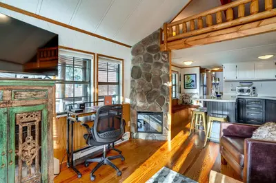 a living room with a desk and a chair at 4 Mi to Slopes! Breck Mtn Base with Hot Tub Access in Breckenridge