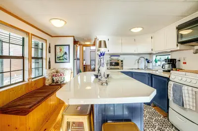 a kitchen with blue cabinets and a white counter top at 4 Mi to Slopes! Breck Mtn Base with Hot Tub Access in Breckenridge