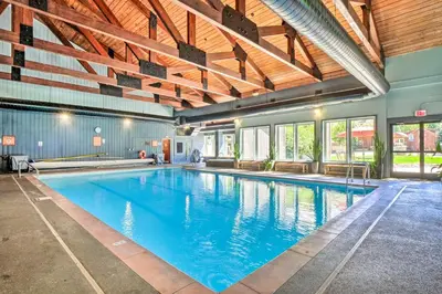 a large swimming pool with blue water in a building at 4 Mi to Slopes! Breck Mtn Base with Hot Tub Access in Breckenridge