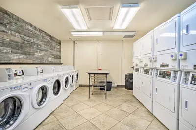 a laundry room with white washing machines and a table at 4 Mi to Slopes! Breck Mtn Base with Hot Tub Access in Breckenridge