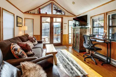 a living room with a couch and a desk at 4 Mi to Slopes! Breck Mtn Base with Hot Tub Access in Breckenridge