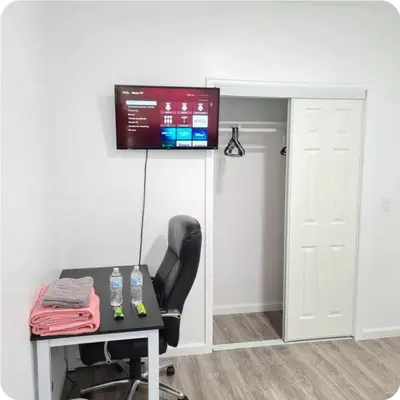 a room with a desk and a television on a wall at Comfort stay near Denver airport in DEN