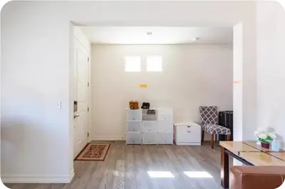 a white living room with a table and a dining room at Comfort stay near Denver airport in DEN
