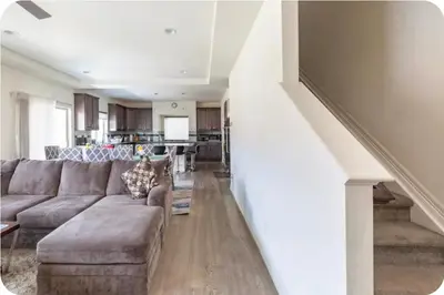 a living room with a couch and a kitchen at Comfort stay near Denver airport in DEN
