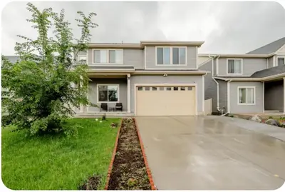 a large house with a driveway and a garage at Comfort stay near Denver airport in DEN