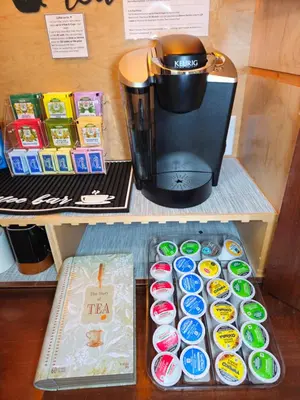 a counter with a coffee maker and cupcakes on a shelf at Stylish Denver Apartment Near Downtown Sleeps 4 in Denver