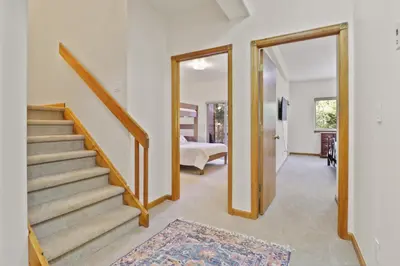 a hallway with a staircase leading to a bedroom at 97 Lookout Ridge townhouse in Dillon