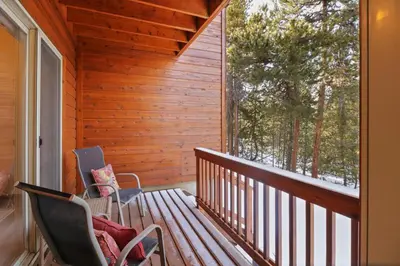 a porch with two chairs and a bench at 97 Lookout Ridge townhouse in Dillon
