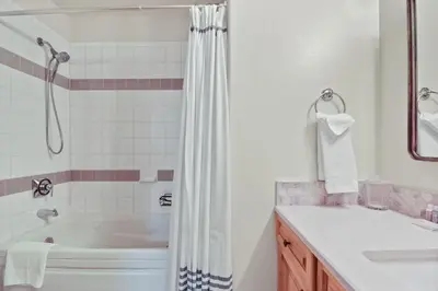 a white bathroom with a tub and a sink at 97 Lookout Ridge townhouse in Dillon