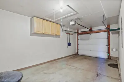 a garage with a white wall and a wooden door at 97 Lookout Ridge townhouse in Dillon