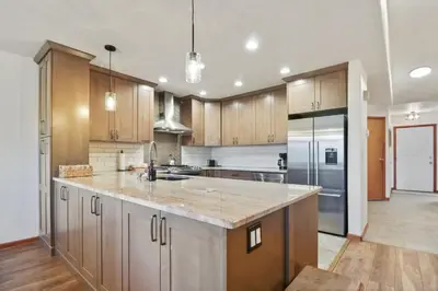 a kitchen with wooden cabinets and stainless steel appliances at 97 Lookout Ridge townhouse in Dillon