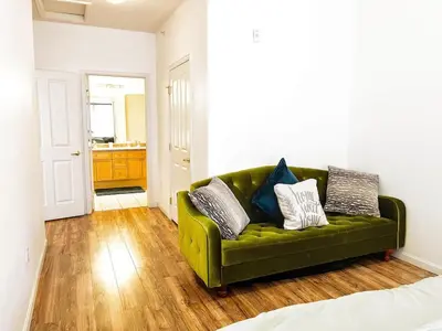 a green couch with pillows on it in a room at Bright Airy Home with Scenic Views in Littleton