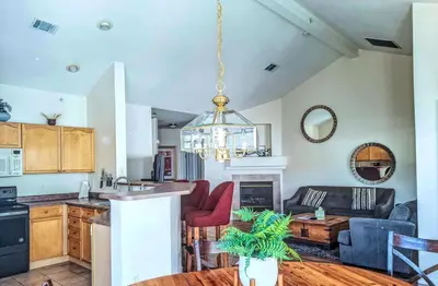 a kitchen and living room with a chandelier at Bright Airy Home with Scenic Views in Littleton
