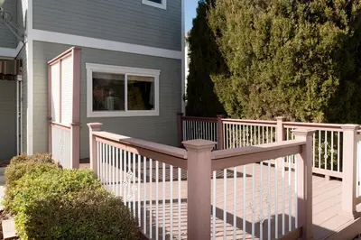a house with a wooden deck with a fence at Spacious Single Family Home in the Heart of Denver in Denver