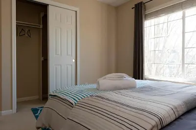 a bedroom with a large bed with a window at Spacious Single Family Home in the Heart of Denver in Denver