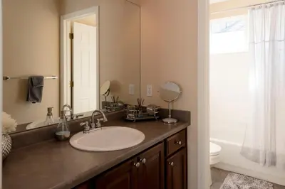 a bathroom with a sink and a mirror at Spacious Single Family Home in the Heart of Denver in Denver