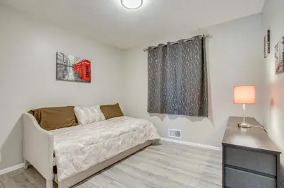 a bedroom with a bed and a television in it at Hot Tub, Fire Pit! Group-Ready Stay Near Denver in Commerce City