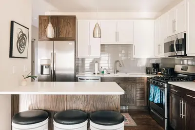 a kitchen with white cabinets and black appliances at Lakefront - Trails - Skiing - Views - Georgetown in Georgetown