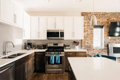 a kitchen with white cabinets and a stove top oven at Lakefront - Trails - Skiing - Views - Georgetown in Georgetown